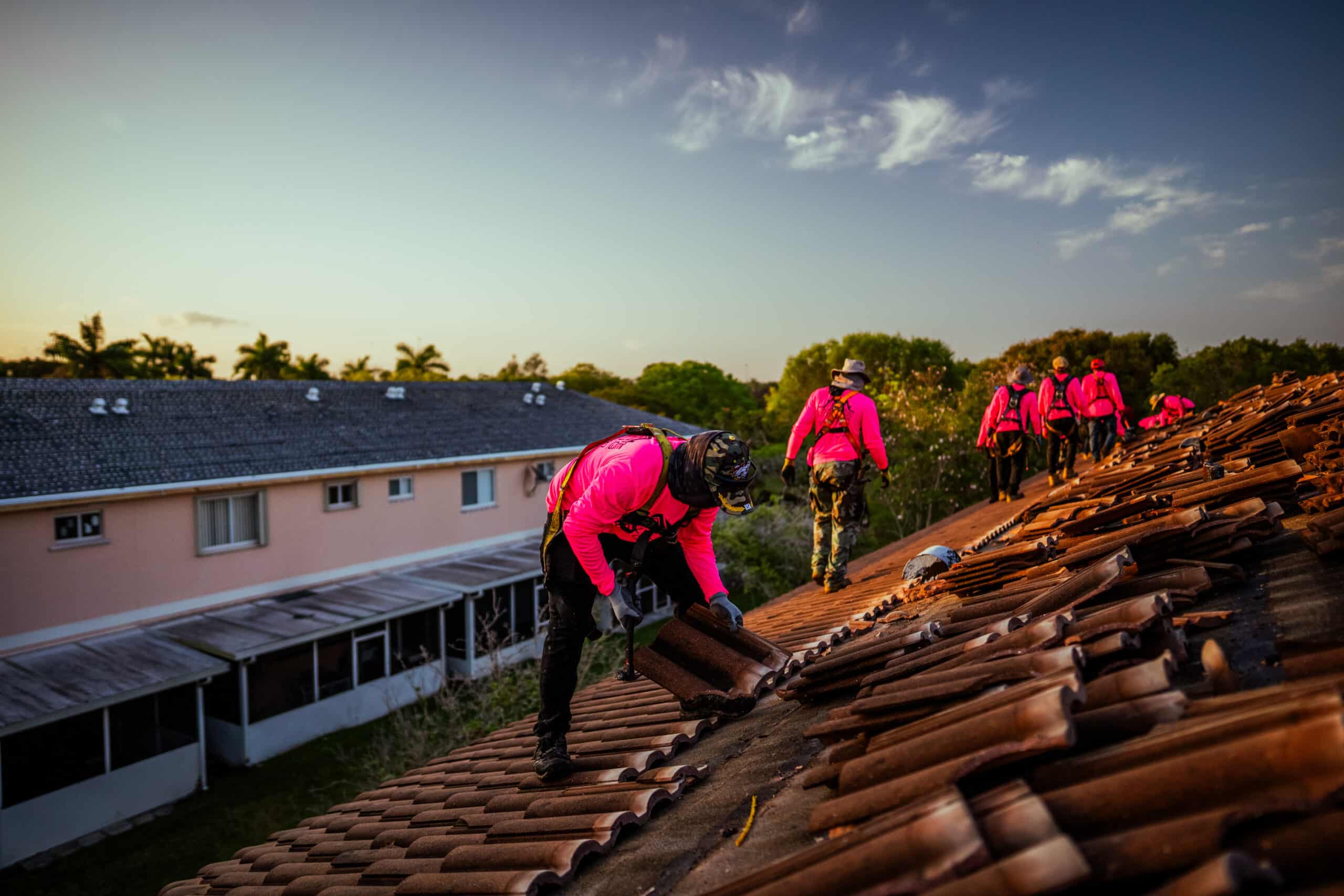 Roofers laying a tile roof